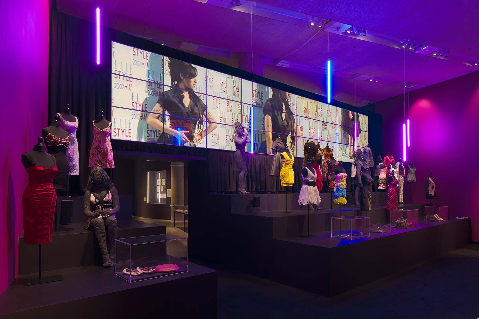 The fashion section, displaying garments that Amy wore to key performances against a backdrop of screens examining her unique style